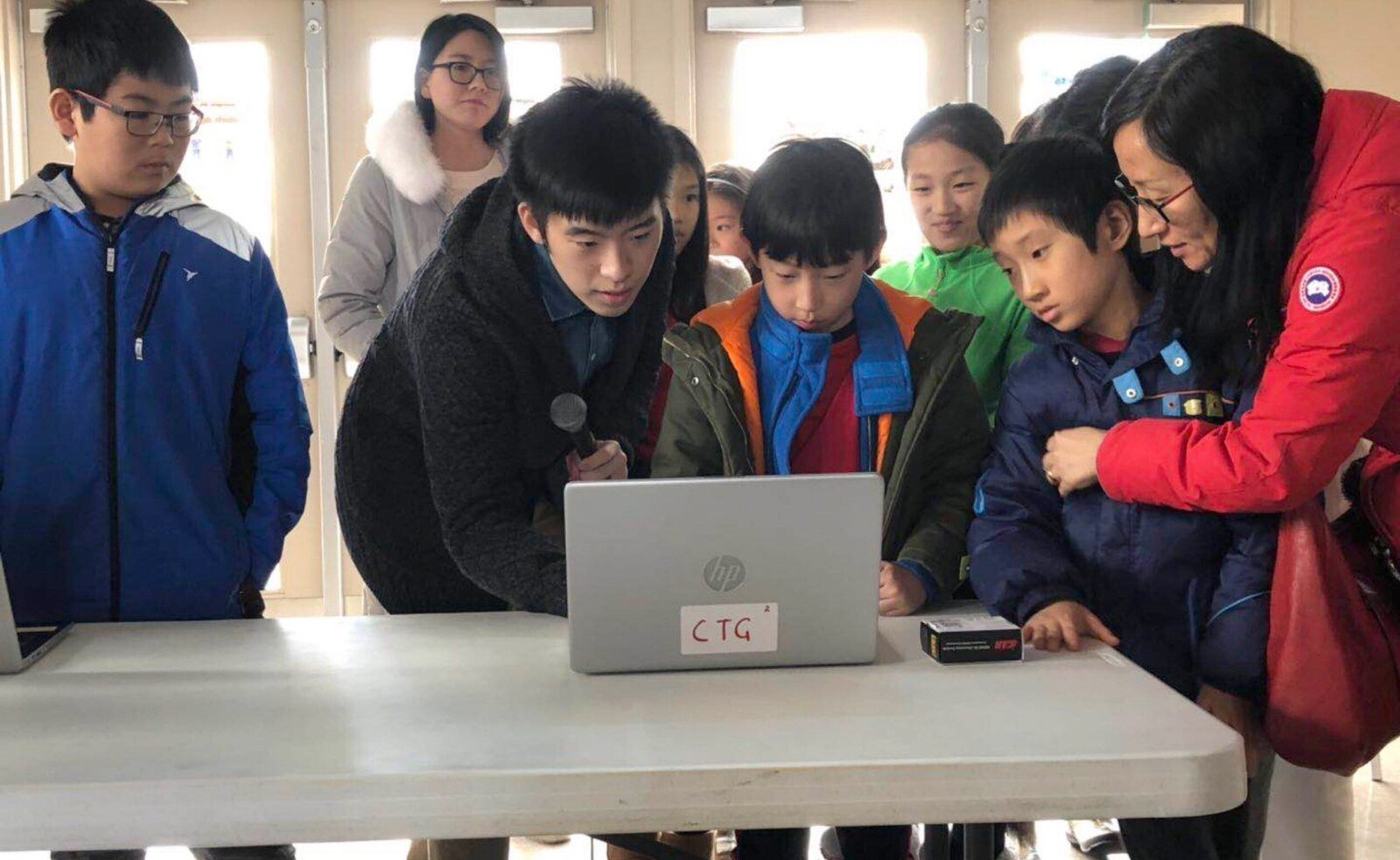 Young participants gathered around a DLCT computer project